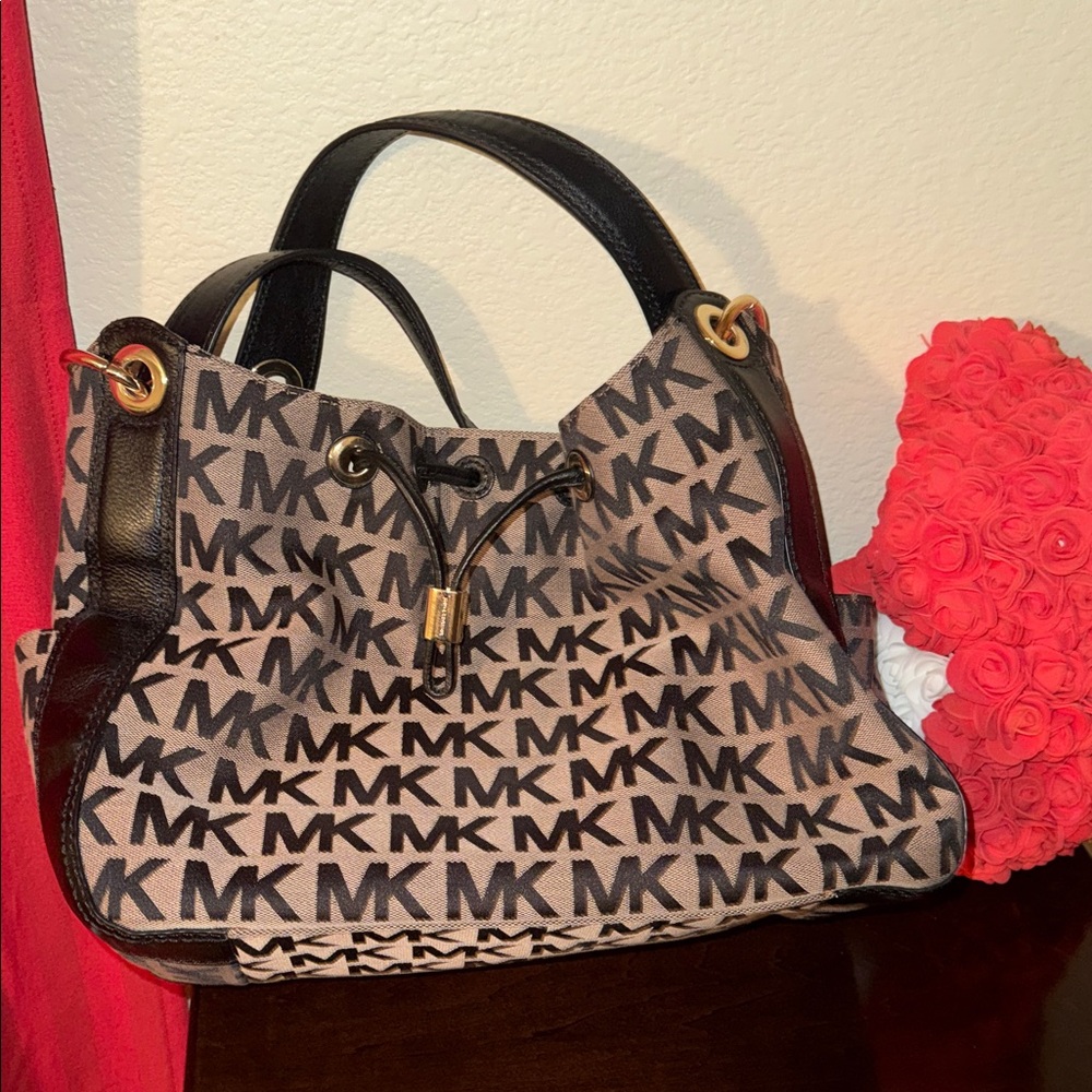 Upgrade your closet with Michael Kors Black and Tan Logo Shoulder Bag